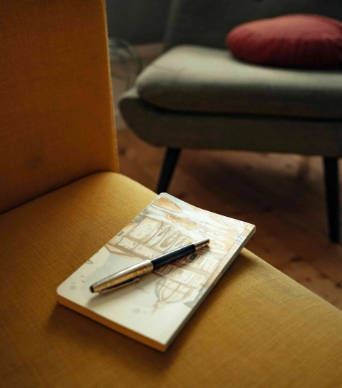 Un carnet et un stylo posés sur un fauteuil, dans l'espace de Lille Hellemmes